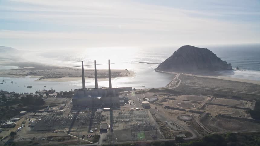 Aerial panorama of a power plant with large chimneys in a seaside electrical sector