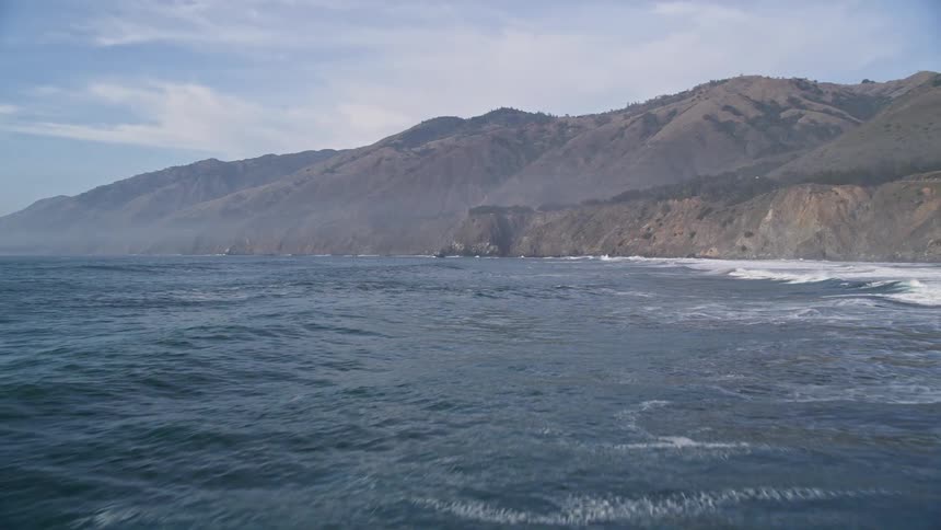 The ocean hitting a coastal mountain range