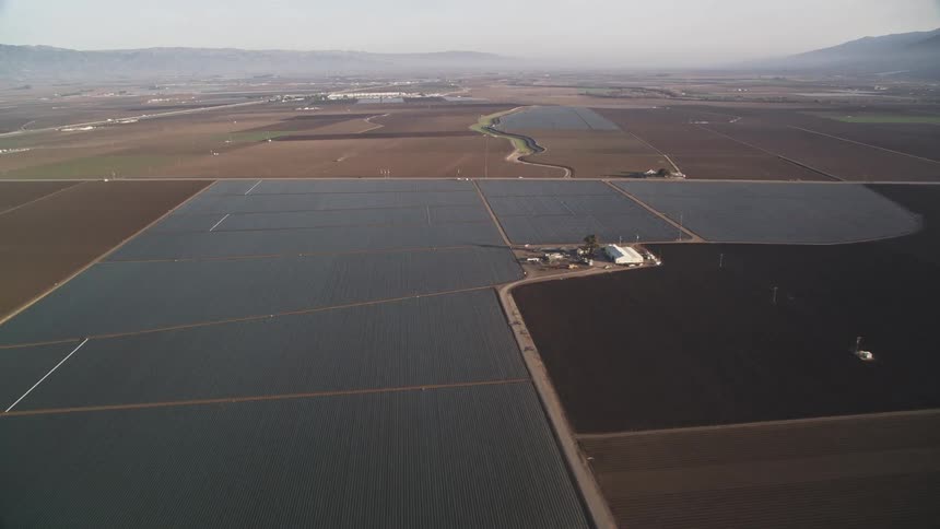 Aerial panorama of rural and agricultural areas with mountains on the horizon