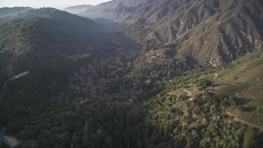 Aerial scenery of greenish mountain ranges with forests during daytime