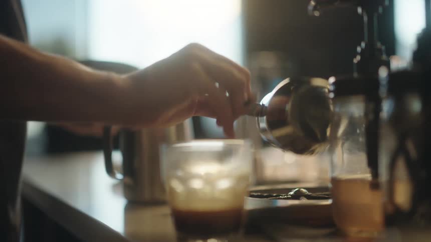 Hands of a man preparing a cappuccino