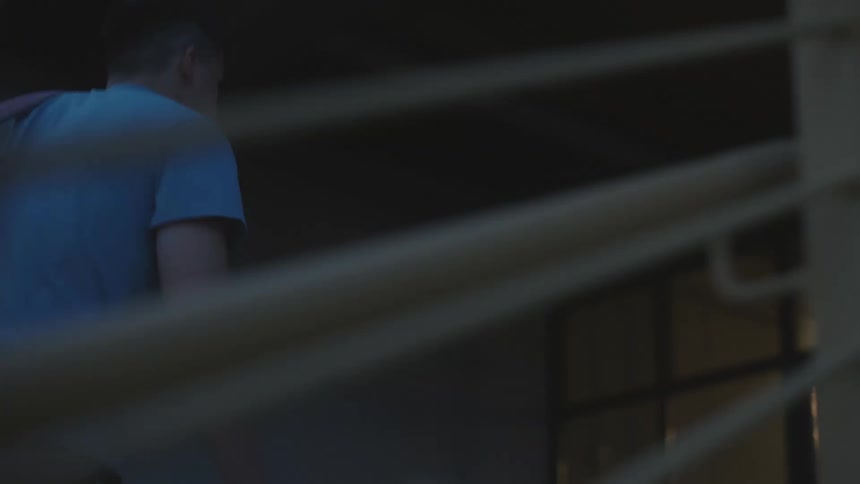 A man enters a building at dawn