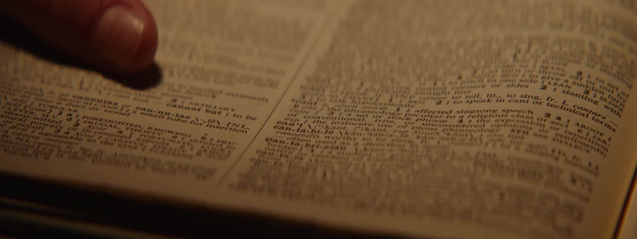 A person marks a piece of text in a book