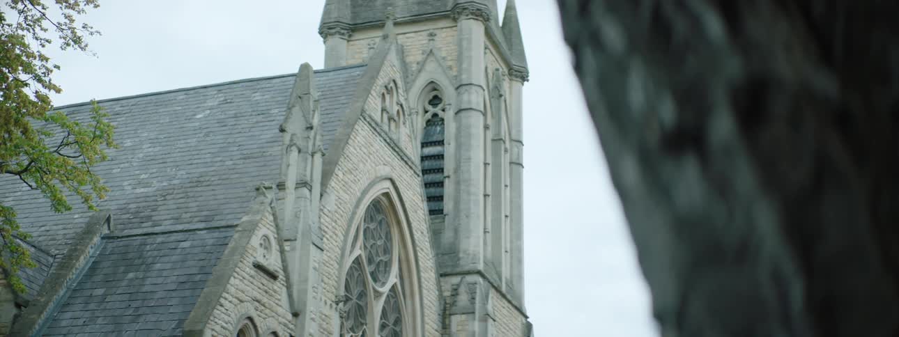 Side of a rustic cathedral on a cloudy day