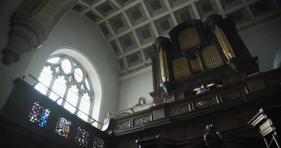 Interior of a church with an altar and a rustic ceiling