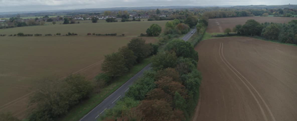 A car drives down the long road