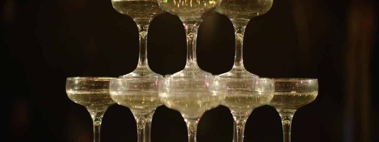 A multitiered tower constructed from champagne flutes