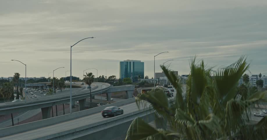 Aerial panorama of a highway with overpasses with vehicle traffic in an urban city