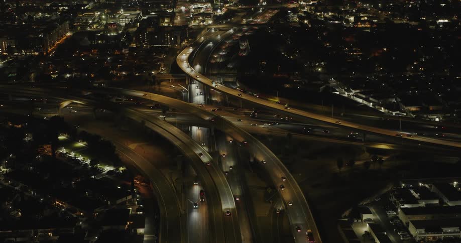 Panorama of an urban city with vehicle traffic at night on highways and overpasses