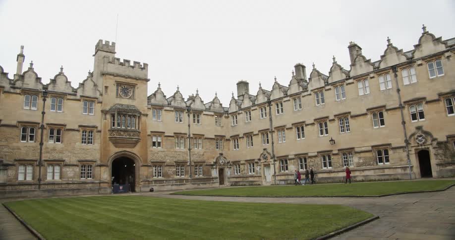 Tourists walk around the outside of the manor