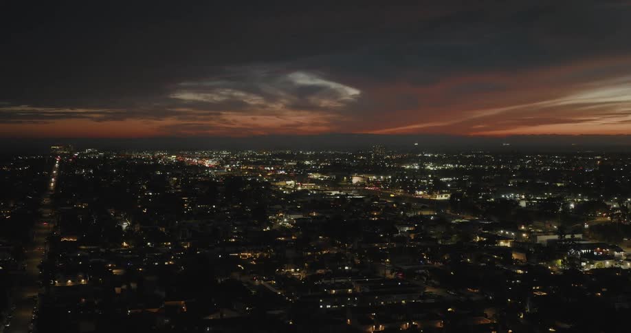 An aerial view of a city at nigh at sunset