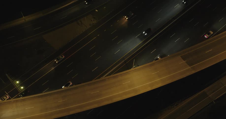 Heavy traffic drives on a highway in a city
