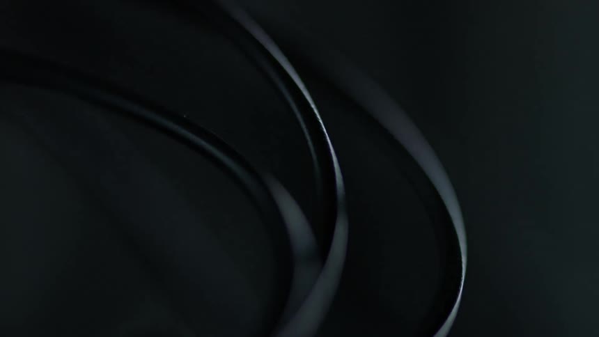 Close up of light and shadows running over black wires