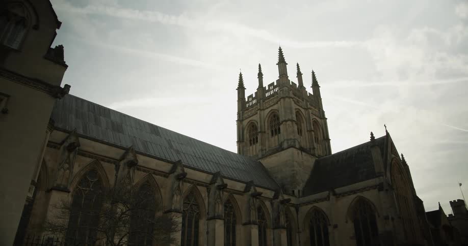 A bus rumbles by an ancient building