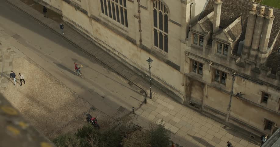 Pedestrians walking and riding bicycles on an old european city