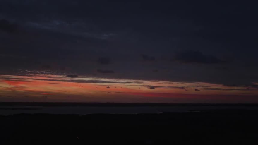 Landscape of a man and a purple and reddish dawn sky