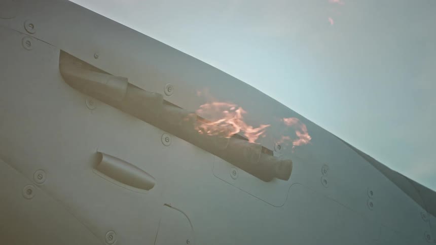 Closeup on the side of a plane with the propeller moving and flames coming out
