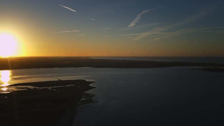 An aerial view of a lake at sunset