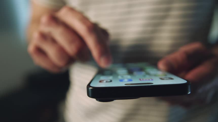 Hands of a person typing on an iphone