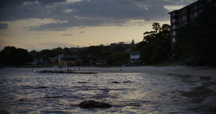 Landscape of a beach with buildings on the shore in a morning sky