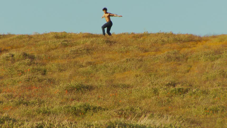 A man is dancing on the hill