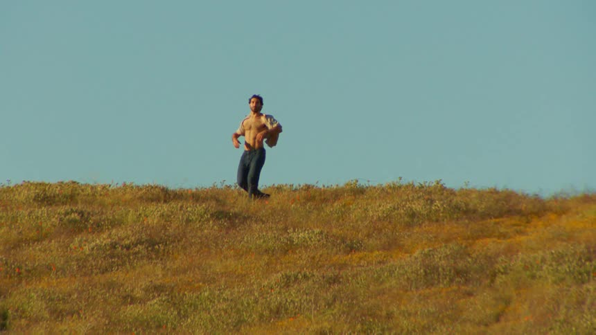 A man dances in a field