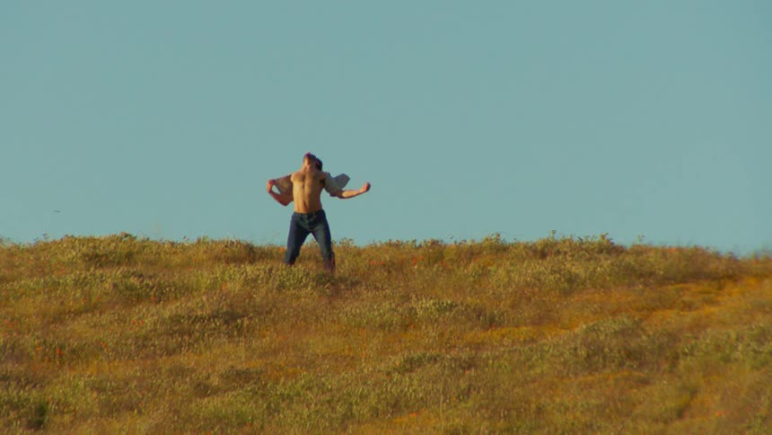A man is dancing on the hill