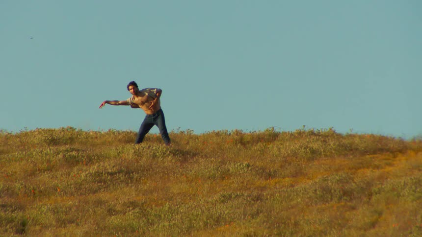 Man on a plateau with grass dancing