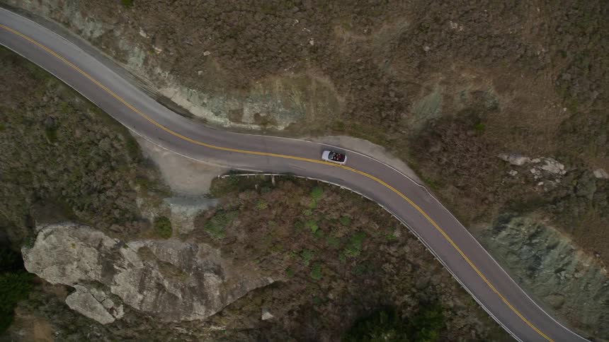 A car drives on a winding road