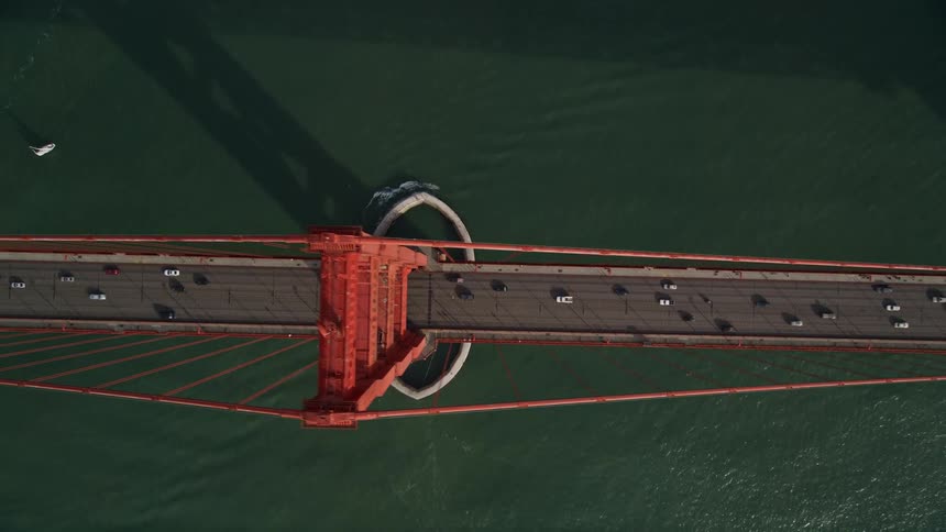 An aerial view of six lanes for cars and trucks in the golden gate bridge