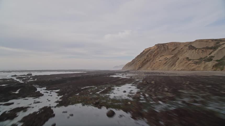 Ocean waves batter a long coastline
