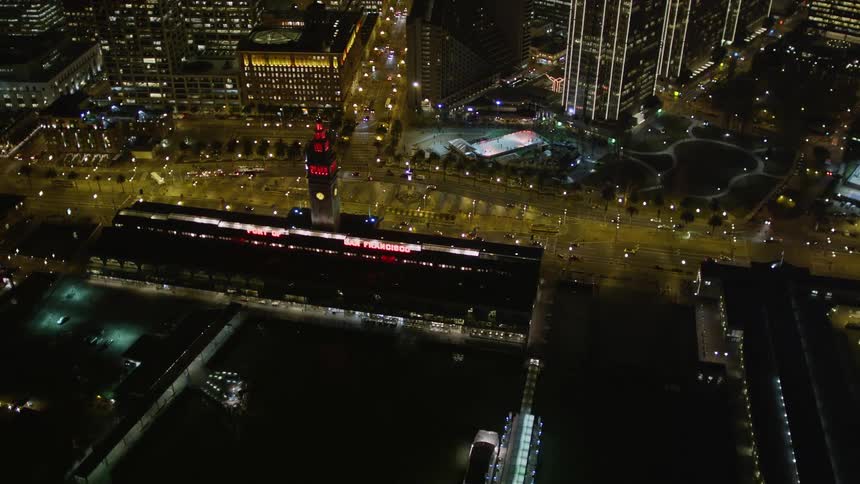 An aerial view of a city at night with roads