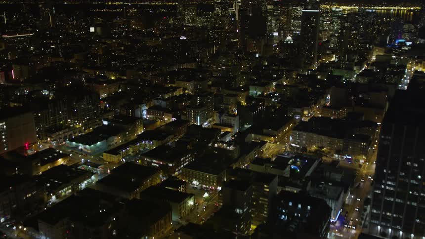 Traffic moves through a city at night