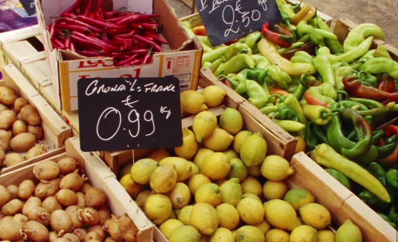 The crates are full of fruits and vegetables for sale