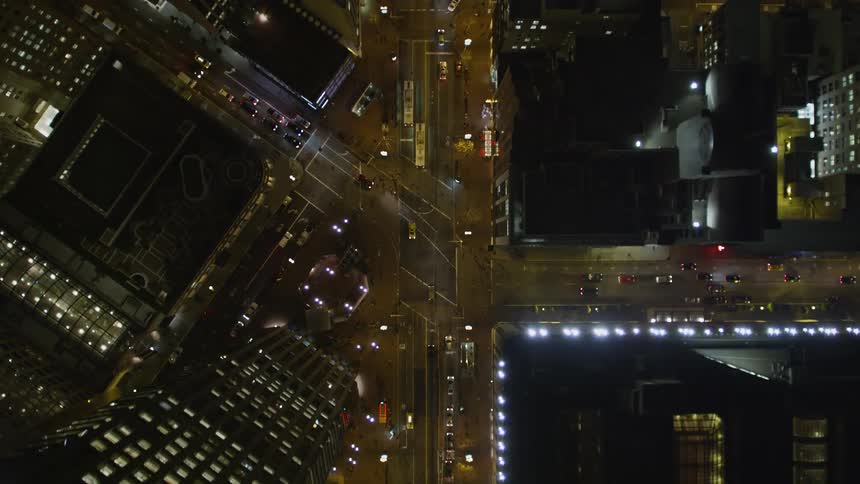 Vehicles drive through the city at night