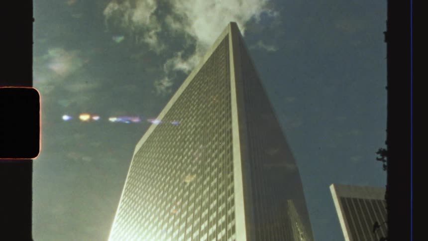 Mirrored commercial building with sunlight reflection during daytime