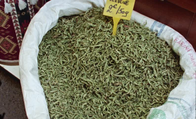 A sack filled with green herbs and a yellow price tag