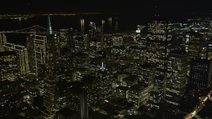 Panorama of a city with large urban and commercial buildings illuminated at night