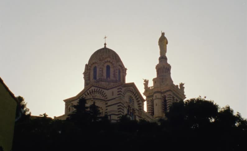 Exterior architecture of a church with a dome and a monument in a morning