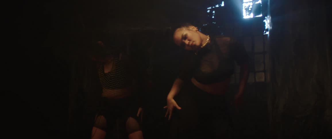 Two women are dancing in sequence
