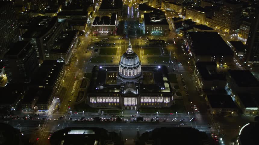 Aerial panorama of a metropolis at night with a palace in the city center