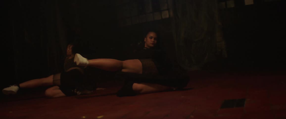 Two young women dancing street dance in a joint choreography