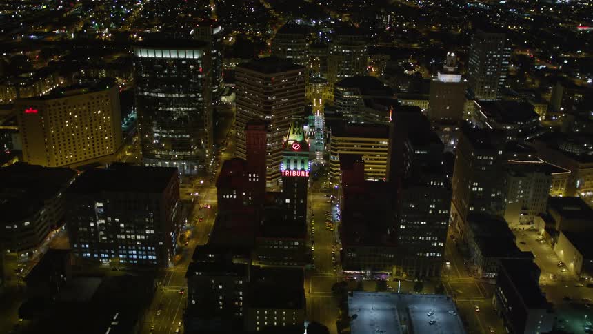 Aerial of a clock tower at night in a metropolis