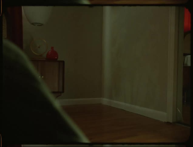 Headlights create a pattern on a wall in a house