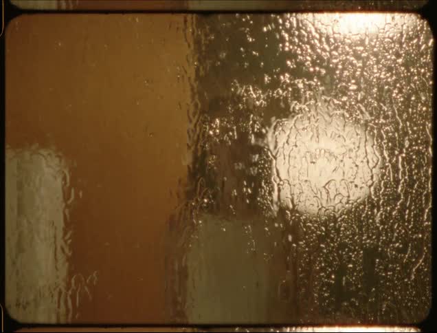 Window with rain running down and portrait of a young woman and woman appearing