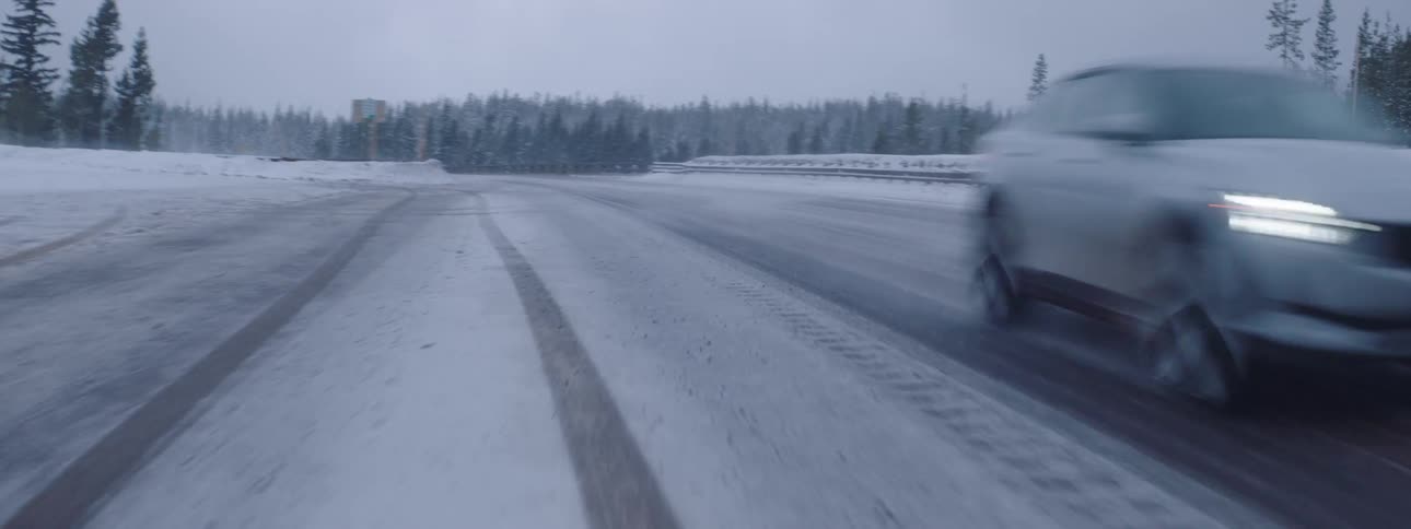 A car speeding on a snowy road