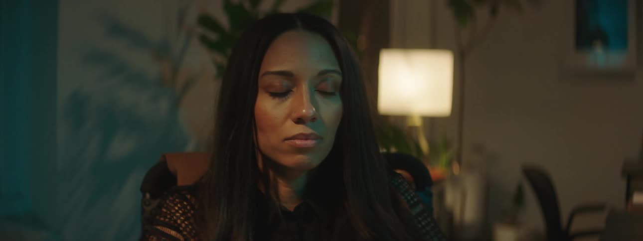 Portrait of a woman in an office room closing her eyes and opening them with a happy expression