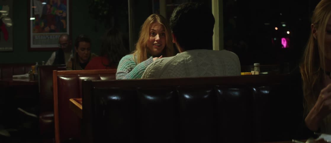 Couple sitting at a restaurant table talking happily