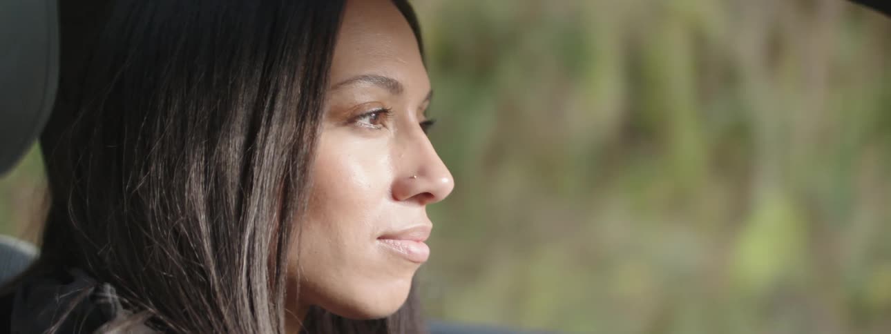 Close up of the face of a woman driving a car