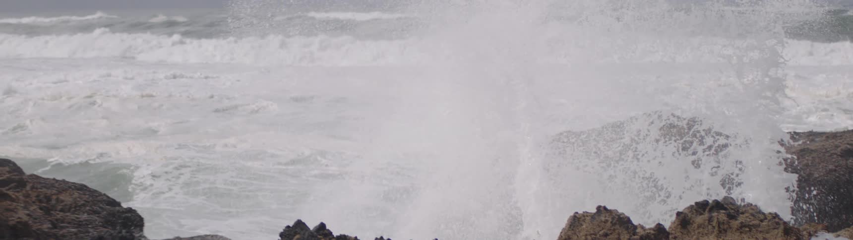 A rugged shoreline with waves crashing against the rocks